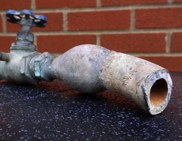 An example of lead pipes that deliver water to the nation's homes is on display. (Seth Perlman/AP Photo)