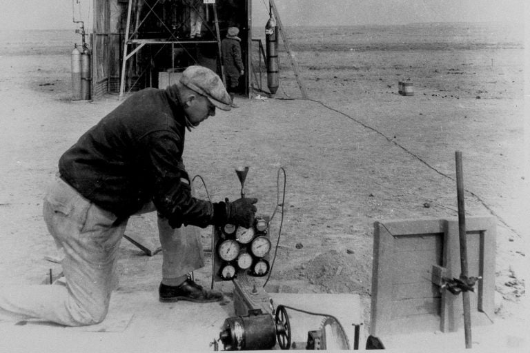 Dr. Robert H. Goddard is pictured working on his experimental rockets in Roswell, N.M. in an undated photo. (AP Photo)