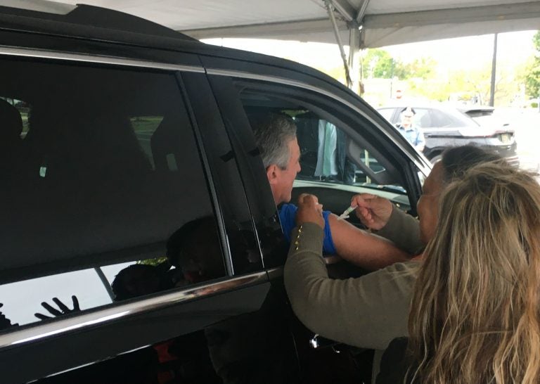 Hundreds of people, including Delaware Gov. John Carney, got their flu vaccine during a drive-thru clinic in Dover on Tuesday. (Mark Eichmann/WHYY)