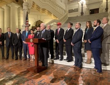 Navy Secretary Richard V. Spencer announces the name of the new ship, flanked by Pennsylvania and Harrisburg officials. (Katie Meyer/WITF)