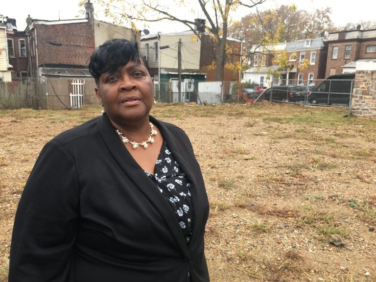 Lottie Lee stands in a vacant lot that will soon become 18 rental units and 16,000 sq. ft. of commercial space. (Mark Eichmann/WHYY)