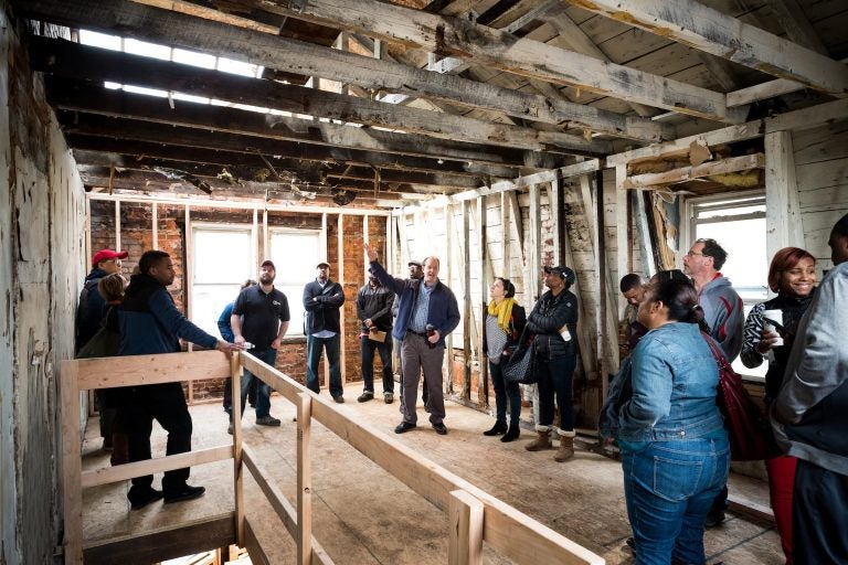 Jumpstart Germantown participants talk development at a project site. (Courtesy of Jumpstart Germantown)