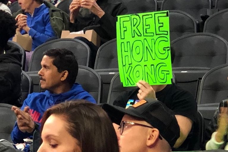 Sam Wachs holds a sign that reads 'Free Hong Kong' at the Sixers pre-season game. (Courtesy of Sam Wachs)