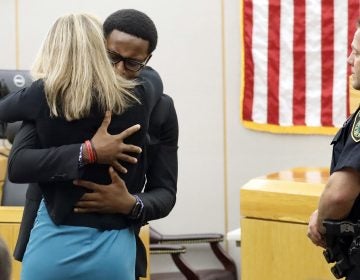 Botham Jean's younger brother Brandt Jean hugs convicted murderer and former Dallas Police Officer Amber Guyger after delivering his impact statement to her after she was sentenced to 10 years in jail, Wednesday, Oct. 2, 2019, in Dallas. Guyger shot and killed Botham Jean, an unarmed 26-year-old neighbor in his own apartment last year. She told police she thought his apartment was her own and that he was an intruder. (Tom Fox/The Dallas Morning News via AP, Pool)