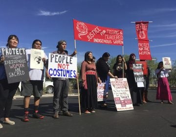 Native American protesters stand outside the Phoenix office of a retailer of 