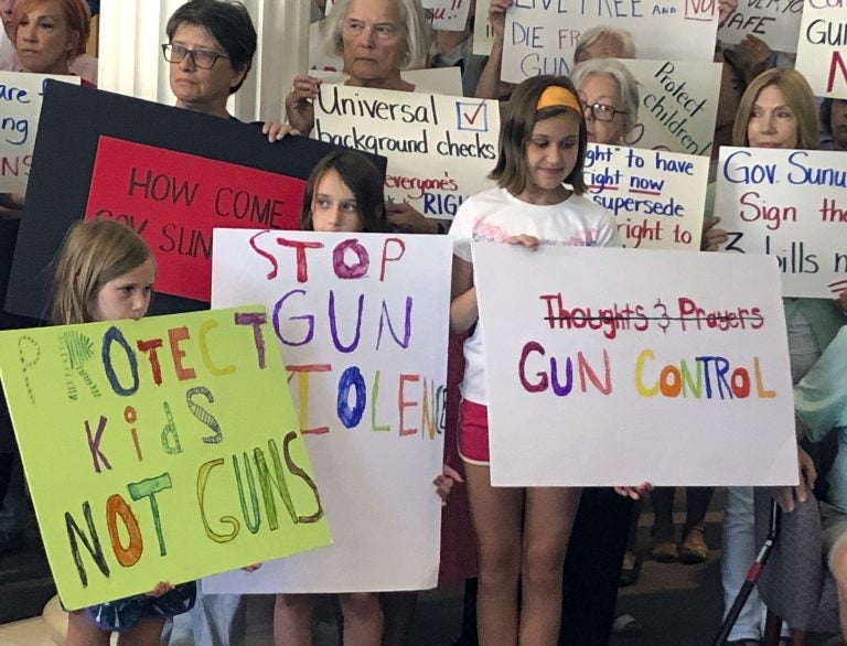 Supporters of gun control measures gather at the Legislative Office Building in Concord, N.H., in August, to urge Republican Gov. Chris Sununu to act after mass shootings in Texas and Ohio. (Michael Casey/AP Photo)