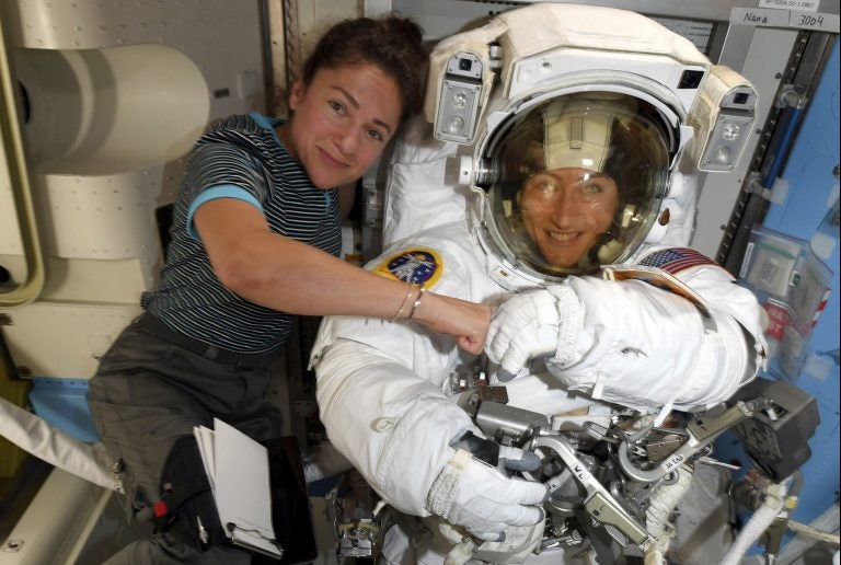 Astronauts Christina Koch (right) and Jessica Meir pose for a photo on the International Space Station on Oct. 4. NASA moved up the first all-female spacewalk because of a power system failure at the space station. (NASA via AP)
