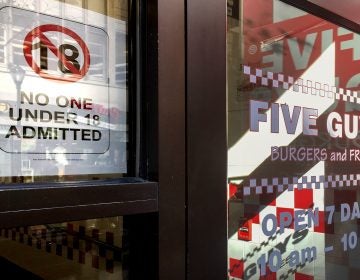 A sign in the door of a Center City Five Guys bans kids under 18 from entry (Michaela Winberg/Billy Penn )