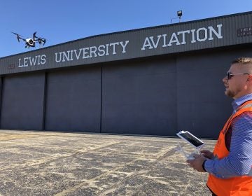 Jacob Reed, director of the Unmanned Aircraft Systems degree program at Lewis University, demonstrates a drone at the school's airfield outside of Chicago. (David Schaper/NPR)