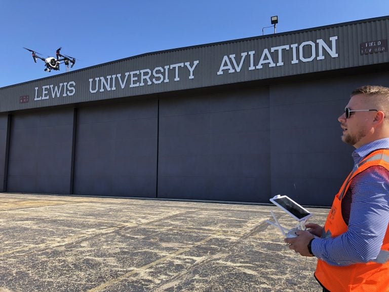 Jacob Reed, director of the Unmanned Aircraft Systems degree program at Lewis University, demonstrates a drone at the school's airfield outside of Chicago. (David Schaper/NPR)