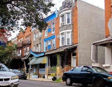 Some homes in the 3700 block of North 15th Street, where six Philadelphia police officers were wounded during a shoot out in August, still have the bullet holes. (Emma Lee/WHYY)