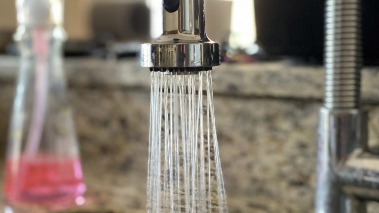 running water in a kitchen sink.