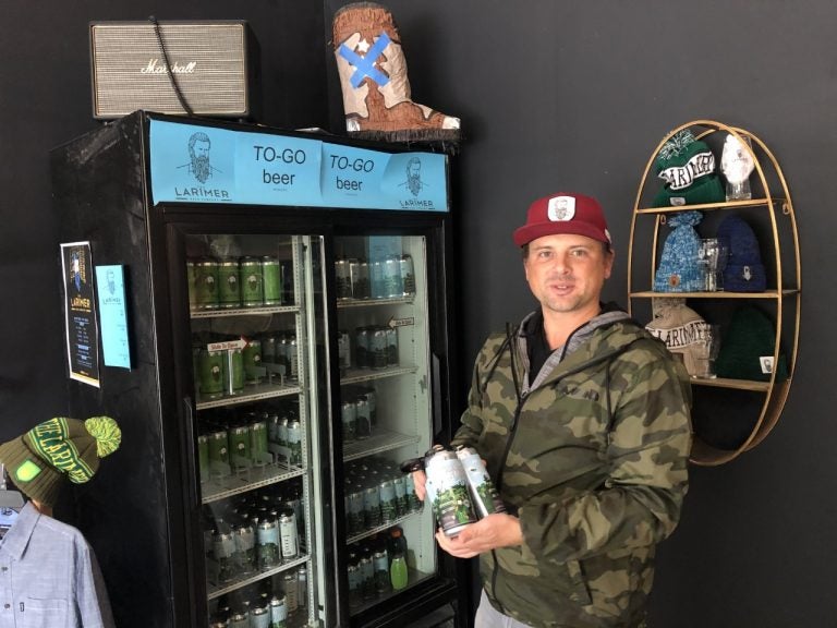 Matt Lindenmuth, founder of the Larimer Beer Company, holds the company’s latest creation “Bird Gang IPA” which debuted Oct. 13. (P. Kenneth Burns/WHYY)