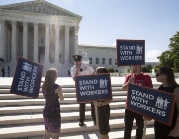 union-dues-government-workers-1920×1280 People gather at the Supreme Court awaiting a decision in an Illinois union dues case, Janus vs. AFSCME, in Washington, Monday, June 25, 2018. The outcome of that case and several others were not announced Monday as the court's term comes to a close. (J. Scott Applewhite/AP Photo)