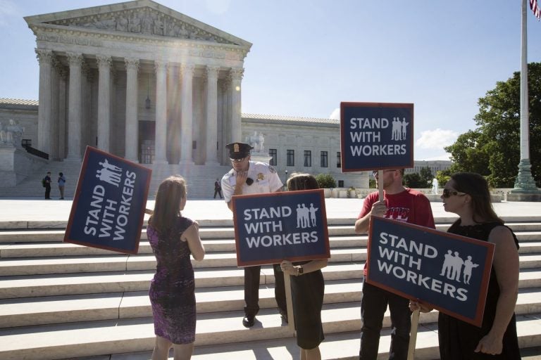 People gather at the Supreme Court awaiting a decision in an Illinois union dues case, Janus vs. AFSCME, in Washington, Monday, June 25, 2018. The outcome of that case and several others were not announced Monday as the court's term comes to a close. (J. Scott Applewhite/AP Photo)