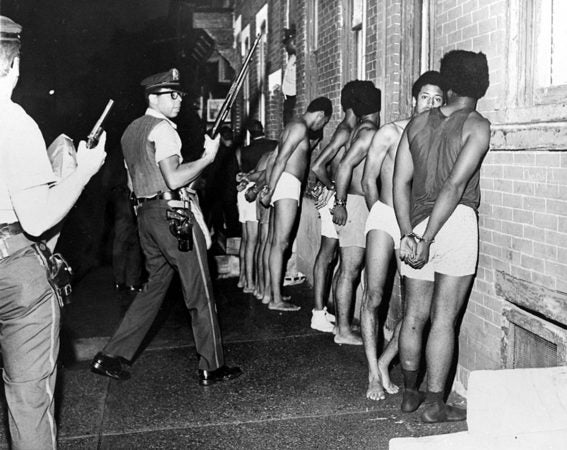 Members of the Black Panther Party, stripped, handcuffed, and arrested after Philadelphia police raided the Panther headquarters, August, 1970. El-Mekki’s father, Hamid Khalid, is 3rd from right. (Photo courtesy of Urban Archives, Temple University)
