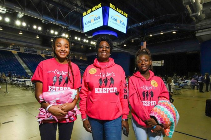 Volunteers (from left) Aniua Brown, 14, Charlotte Miller-Lacy and Christina Cooper, 17, from I am My Sister’s Keeper during Kind to Kids Foundation’s 4th Annual My Blue Duffel Community Service Day Sunday.  (Saquan Stimpson for WHYY)