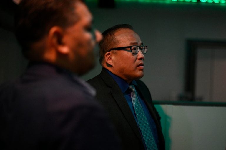 Incumbent Councilman at-Large David Oh follows the results at Dimensions Sports Bar in Northeast Philadelphia. (Bastiaan Slabbers for WHYY)