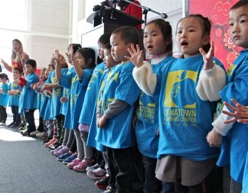 Young students from the Chinatown Learning Center sing during the grand opening of the Crane Chinatown community center. (Emma Lee/WHYY)