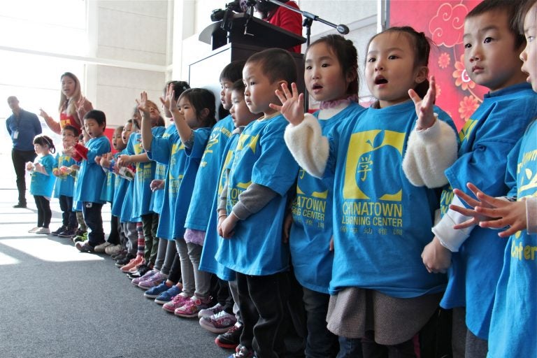 Young students from the Chinatown Learning Center sing during the grand opening of the Crane Chinatown community center. (Emma Lee/WHYY)