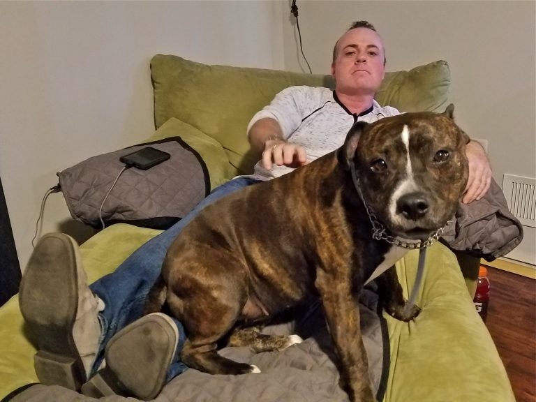 Patrick Hennessy with his pitbull Roxy at his home in Bayville, N.J. (Nicholas Pugliese/WHYY)