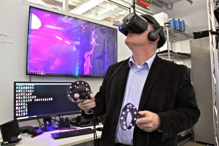 Nick Jushchyshyn, Program Director of Virtual Reality; Immersive Media at Drexel University, watches a dance performance using a virtual reality headset at the school's new Immersive Research Lab. (Emma Lee/WHYY)