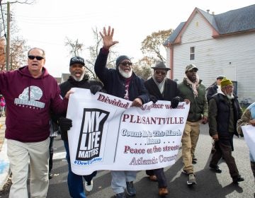 A group of male community leaders lead the march in recognition of the particular impact gun violence has on black men in the community. (Becca Haydu for WHYY)