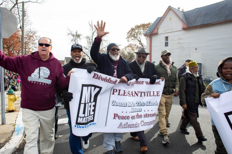 A group of male community leaders lead the march in recognition of the particular impact gun violence has on black men in the community. (Becca Haydu for WHYY)