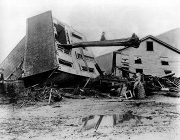 In this historical photo from May 31, 1889, survivors stand by homes destroyed when the South Fork Dam collapsed in Johnstown, Pa. As officials prepare to commemorate the 125th anniversary of the enormous Johnstown Flood of 1889 that killed 2,209 people, new research has helped explain why the deluge was so deadly. (AP Photo)