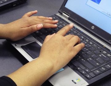 File photo: In this March 13, 2019, photo, a student re-images a laptop in a school computer lab (Carolyn Thompson/AP Photo)