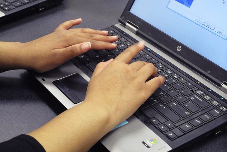 File photo: In this March 13, 2019, photo, a student re-images a laptop in a school computer lab (Carolyn Thompson/AP Photo)