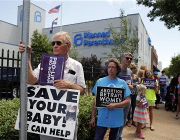 In this June 4, 2019, file photo, Anti-abortion advocates gather outside the Planned Parenthood clinic in St. Louis. (Jeff Roberson / AP Photo)