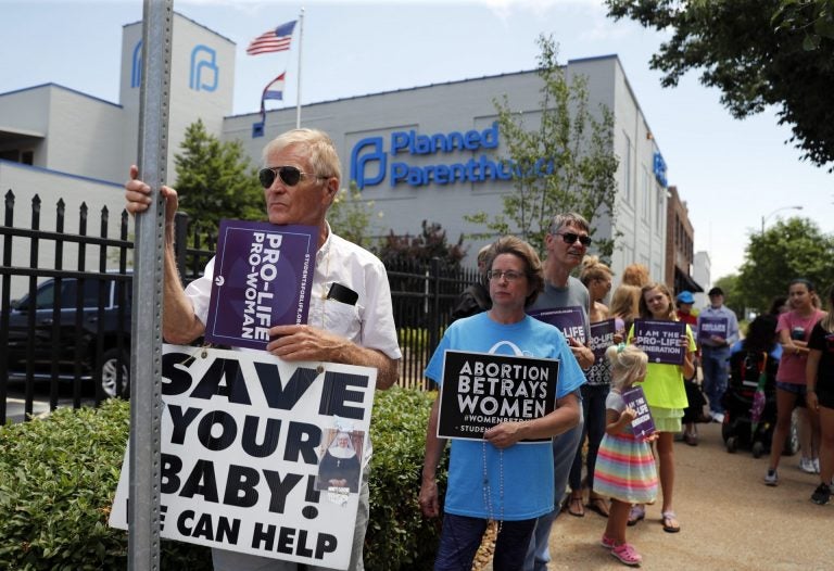 In this June 4, 2019, file photo, Anti-abortion advocates gather outside the Planned Parenthood clinic in St. Louis. (Jeff Roberson / AP Photo)