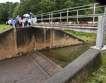 In this Sept. 28, 2019, file photo, officials look at damage to Heller Dam at Hagerman's Reservoir near South Williamsport, Pa. Pennsylvanians who live downstream from its many dams may not often think about what could happen, but inspectors know there are potential threats to life and property along the state's 86,000 miles of streams and rivers. (Mark Nance/Sun-Gazette via AP)