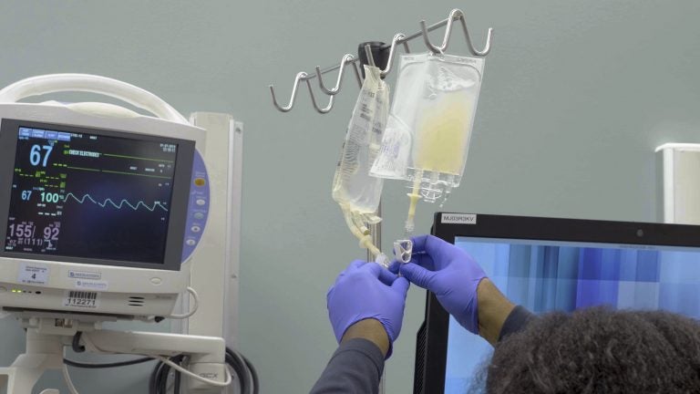 In this January 2019 image made from video provided by Penn Medicine, IV bags of CRISPR-edited T cells are prepared for administering to a patient at the Abramson Cancer Center in Philadelphia. Early results released on Wednesday, Nov. 6, 2019 show that doctors were able to take immune system cells from the patients' blood and alter them genetically to help them recognize and fight cancer, with minimal and manageable side effects. (Penn Medicine via AP)