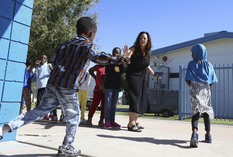 Director Lynette Faulkner, middle, tries to slow down a student at Valencia Newcomer School between classes, in Phoenix. (Ross D. Franklin/AP Photo)