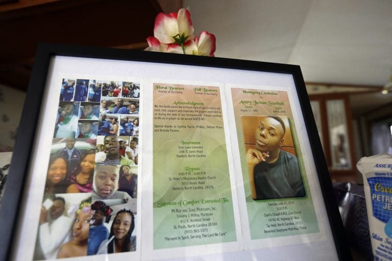 In this photo taken Tuesday, Aug. 6, 2019, a framed copy of Avery Scurlock's memorial is shown in Avery's mother Brenda Scurlock's home in Lumber Bridge, N.C. Avery, who used the name Chanel when dressing as a woman in social settings and hoped to have sex reassignment surgery, was found shot to death in June. This death of a transgender person in North Carolina is one of 18 so far this year, and 17 of the victims have been black women. (Gerry Broome/AP Photo)