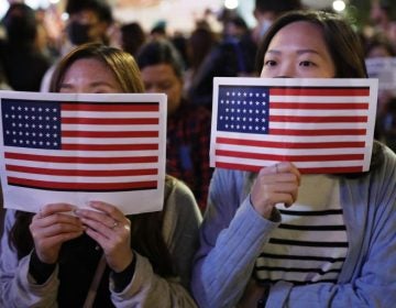 Protester holds U.S. flags during a demonstration in Hong Kong, Thursday, Nov. 28, 2019. China’s fury over President Donald Trump’s decision to sign legislation supporting human rights in Hong Kong is evident. What’s less clear what 'countermeasures' Beijing may take in response to what it said Thursday were 'extremely evil' and dangerous moves. (Vincent Thian/AP Photo)