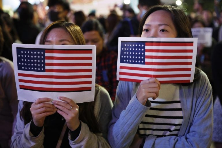 Protester holds U.S. flags during a demonstration in Hong Kong, Thursday, Nov. 28, 2019. China’s fury over President Donald Trump’s decision to sign legislation supporting human rights in Hong Kong is evident. What’s less clear what 'countermeasures' Beijing may take in response to what it said Thursday were 'extremely evil' and dangerous moves. (Vincent Thian/AP Photo)