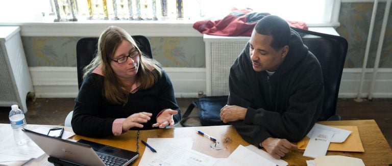 File photo: Erik Furness meets with Antoinette Kraus with the Pennsylvania Health Access Network to begin the process of signing up for insurance under the Affordable Care Act, Monday, March 31, 2014, at Project HOME's St. Elizabeth's Community and Wellness Center in Philadelphia.(Matt Rourke/AP Photo)