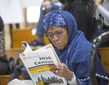 Ruqayya Ali of Center City peruses Philly Counts census literature during the Philly Counts 2020 summit at South Philadelphia High School.
(Jonathan Wilson/WHYY)