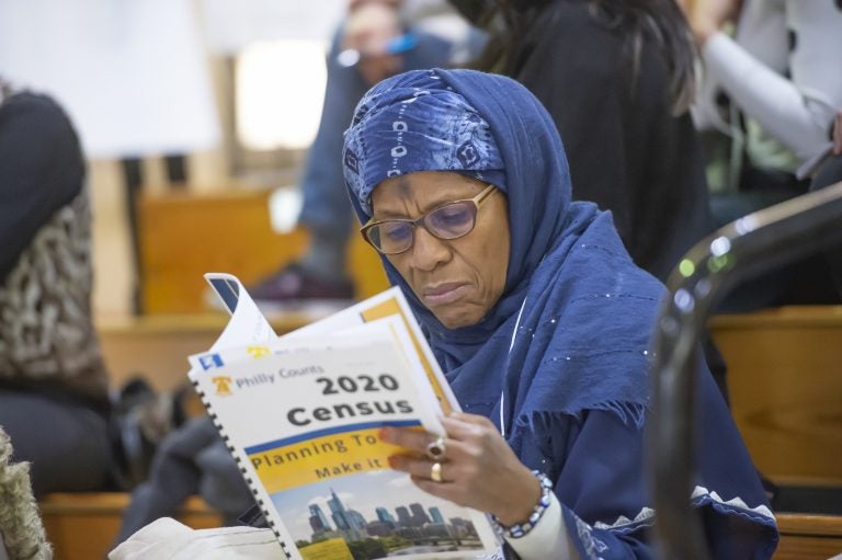 Ruqayya Ali of Center City peruses Philly Counts census literature during the Philly Counts 2020 summit at South Philadelphia High School.
(Jonathan Wilson/WHYY)