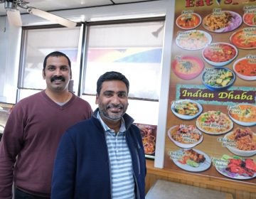 Eat Spice co-owners Vamsi Yaramaka, left, and Raj Alturu stand inside at their truck stop on route 534 off I-80 in White Haven, Pennsylvania. The restaurant offers dishes that are hard to find amid typical American fast food fare. (Matt Smith for Keystone Crossroads)