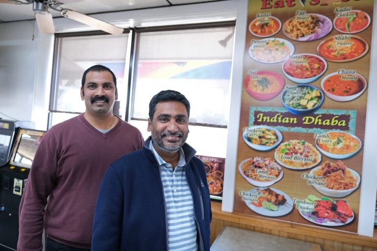 Eat Spice co-owners Vamsi Yaramaka, left, and Raj Alturu stand inside at their truck stop on route 534 off I-80 in White Haven, Pennsylvania. The restaurant offers dishes that are hard to find amid typical American fast food fare. (Matt Smith for Keystone Crossroads)
