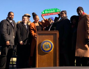 Family members hold up the new street sign named after their patriarch Rev. Dr. Leon H. Sullivan. North Broad Street, between Oxford Street and Girard Avenue, has been renamed Sullivan Way. (P. Kenneth Burns/WHYY)