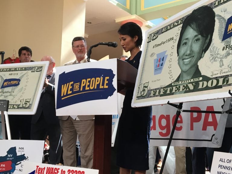Representative Patty Kim speaks at a September 17 rally for a higher minimum wage. Advocates have been using the likenesses of Kim and her co-sponsor, Representative Chris Rabb, in their lobbying effort. (Katie Meyer / WITF)