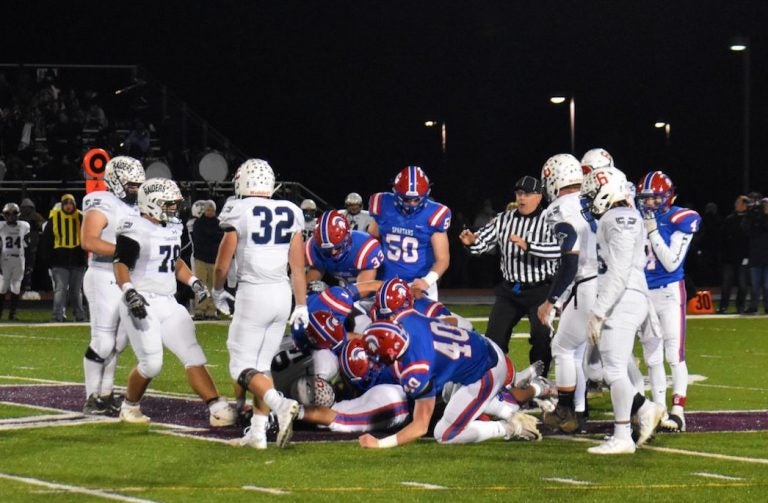 North Schuylkill Spartans and Tamaqua Blue Raiders are in a pile at the end of a play. during a Nov. 8, 2019 playoff game. (Brett Sholtis/WITF)