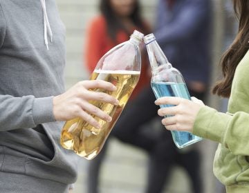 Close Up Of Teenage Group Drinking Alcohol Together