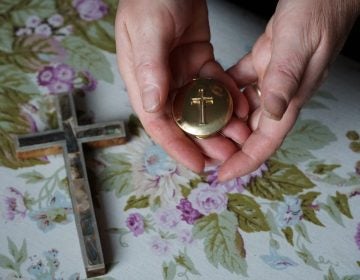 Marie Andrews holds a pyx, the vessel she uses to transport the consecrated Communion wafer to homebound parishioners. Andrews is an officially sanctioned Eucharistic minister in the Roman Catholic Church. (Shahla Farzan/St. Louis Public Radio)