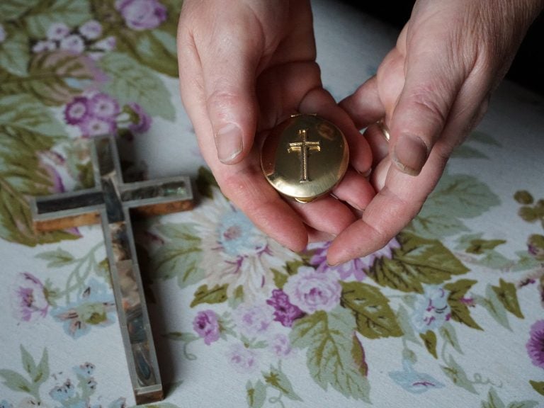 Marie Andrews holds a pyx, the vessel she uses to transport the consecrated Communion wafer to homebound parishioners. Andrews is an officially sanctioned Eucharistic minister in the Roman Catholic Church. (Shahla Farzan/St. Louis Public Radio)